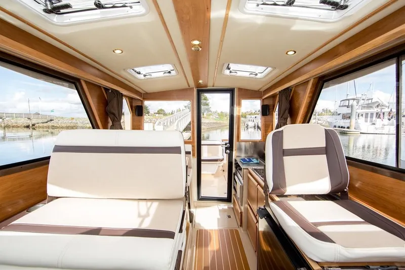 Slide: The Image of Interior of 2019 Cutwater C-28 boat with luxurious seating and panoramic windows. - 49