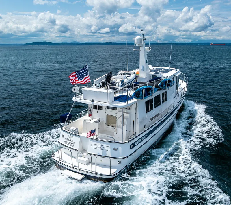 Slide: The Image of Nordic Tug 54 (2007) cruising on open water under a cloudy sky. - 1