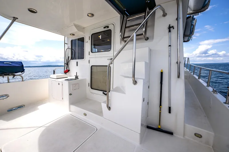 Slide: The Image of Nordic Tug 54 yacht deck, 2007 model, featuring outdoor sink and ocean view. - 14