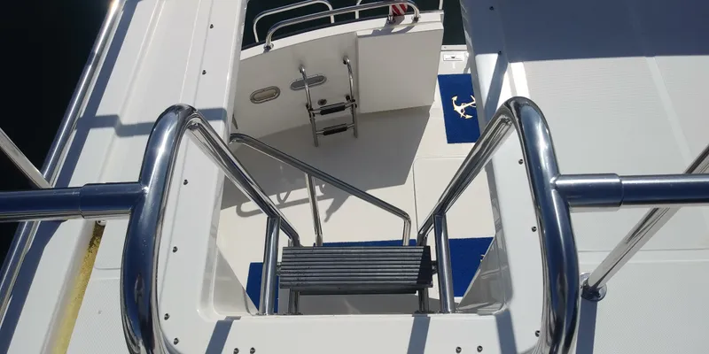 Slide: The Image of Staircase on 2007 Nordic Tug 54 yacht, featuring stainless steel railings and non-slip steps. - 16