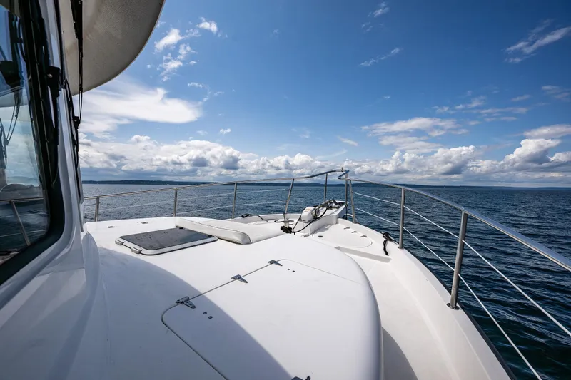 Slide: The Image of 2007 Nordic Tug 54 yacht deck with ocean view under blue sky. - 17