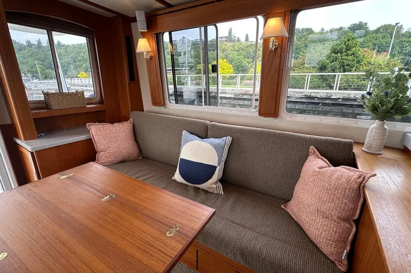 Slide: The Image of Cozy interior of 2007 Nordic Tug 54 with plush seating and decorative pillows. - 25