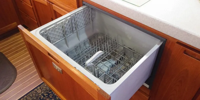 Slide: The Image of Open dishwasher drawer in a 2007 Nordic Tug 54 yacht kitchen. - 27