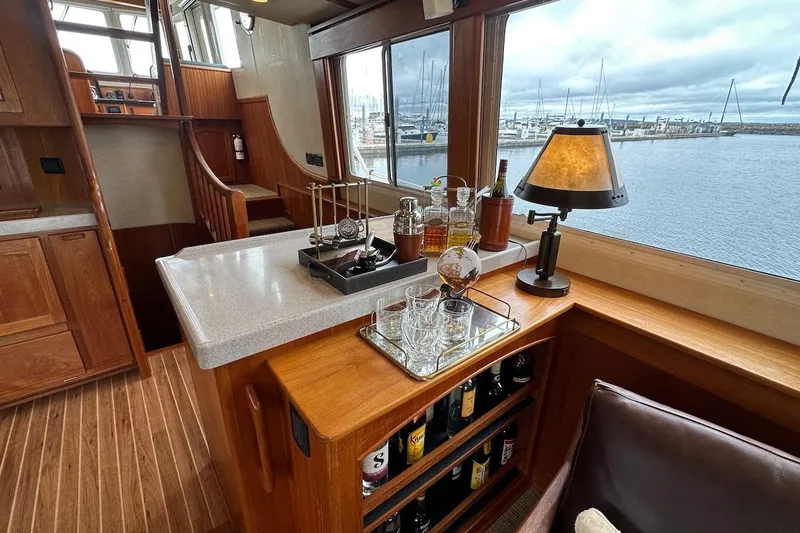 Slide: The Image of Luxurious interior of 2007 Nordic Tug 54 yacht with bar and scenic marina view. - 30