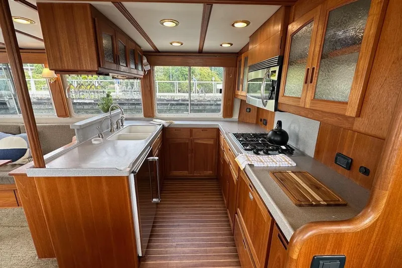 Slide: The Image of Luxurious 2007 Nordic Tug 54 kitchen with wood cabinetry, modern appliances, and large windows. - 32