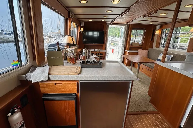 Slide: The Image of Interior of a 2007 Nordic Tug 54 yacht with modern kitchen and cozy seating area. - 35