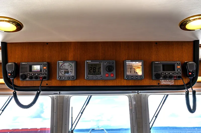 Slide: The Image of Control panel of a 2007 Nordic Tug 54 with navigation and communication equipment. - 43