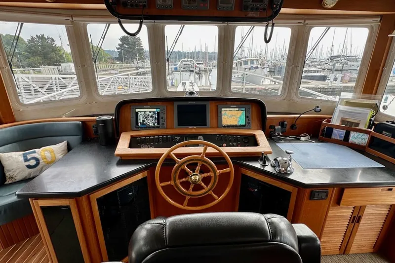 Slide: The Image of Pilothouse of 2007 Nordic Tug 54 with navigation equipment and marina view. - 45
