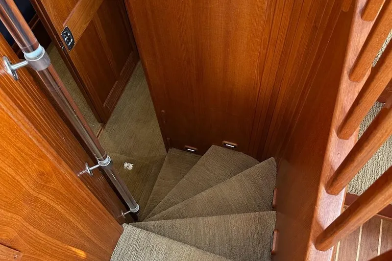 Slide: The Image of Staircase inside 2007 Nordic Tug 54 yacht, featuring wooden walls and carpeted steps. - 47