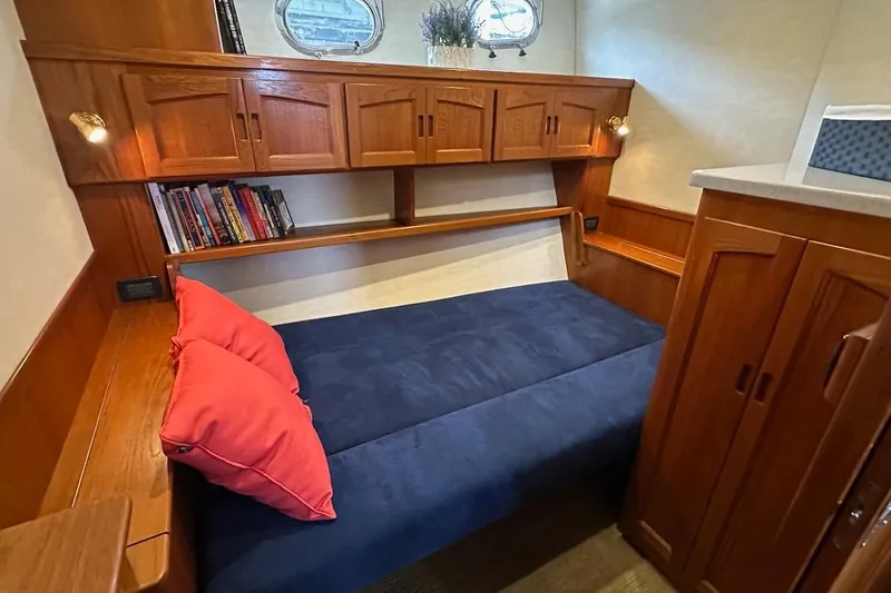 Slide: The Image of Cozy cabin interior of 2007 Nordic Tug 54 with wooden cabinetry and blue bedding. - 50