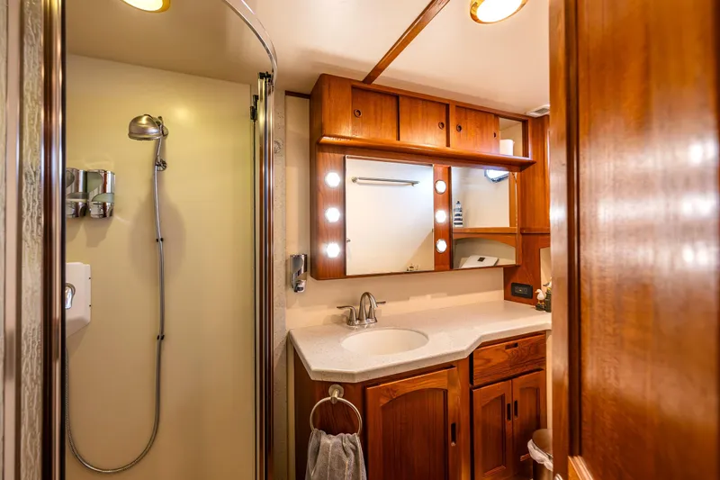 Slide: The Image of Luxurious 2007 Nordic Tug 54 bathroom with wooden cabinetry and modern shower. - 54