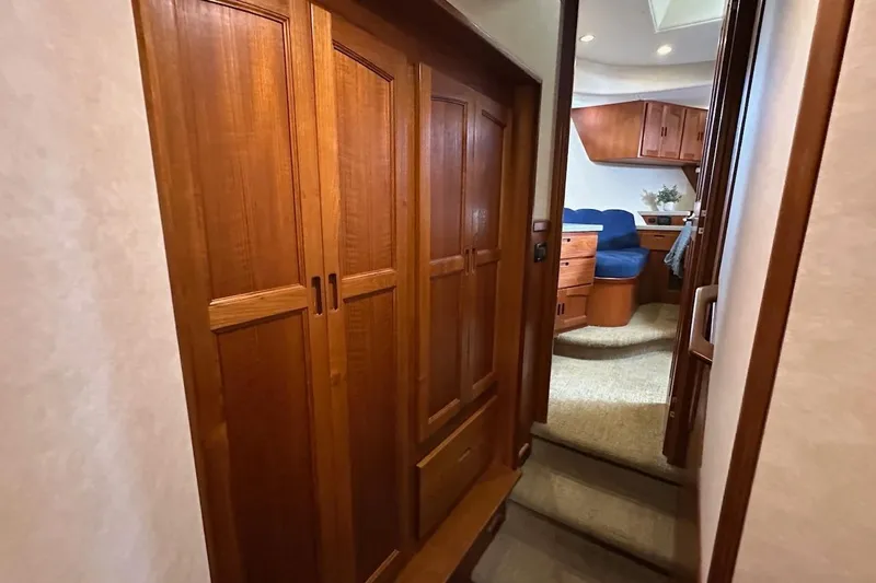 Slide: The Image of Interior of 2007 Nordic Tug 54, featuring wooden cabinetry and cozy seating area. - 57