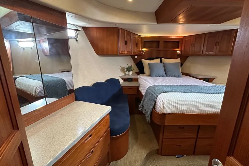 Slide: The Image of Luxurious 2007 Nordic Tug 54 bedroom with elegant wood cabinetry and cozy bedding. - 58
