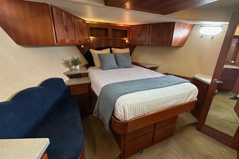 Slide: The Image of Luxurious 2007 Nordic Tug 54 bedroom with cozy bed, wooden cabinets, and elegant decor. - 59
