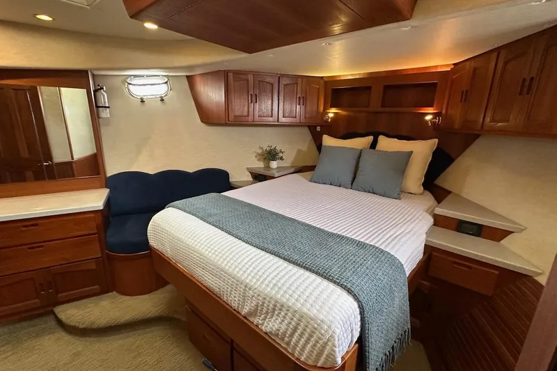 Slide: The Image of Luxurious cabin interior of a 2007 Nordic Tug 54 with cozy bed and wooden cabinetry. - 60