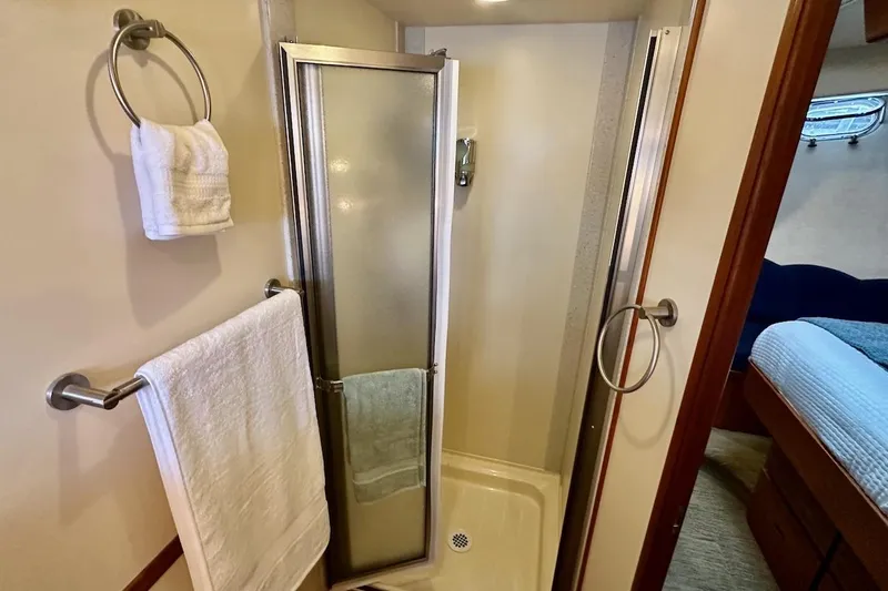 Slide: The Image of Compact bathroom with shower in 2007 Nordic Tug 54 yacht, featuring towel racks and modern design. - 64