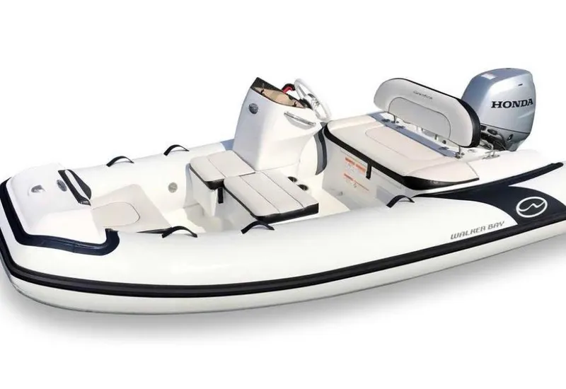 Slide: The Image of A white inflatable boat with Honda outboard motor, featuring seating and steering console. Nordic Tug 54, 2007. - 74