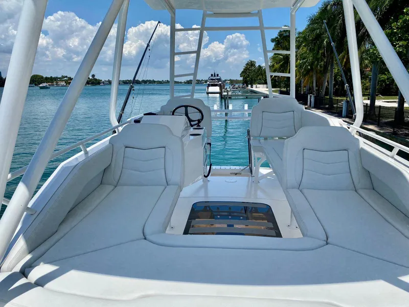 Slide: The Image of Luxurious 2021 Scout 530 LXF boat interior with plush seating and scenic water view. - 12