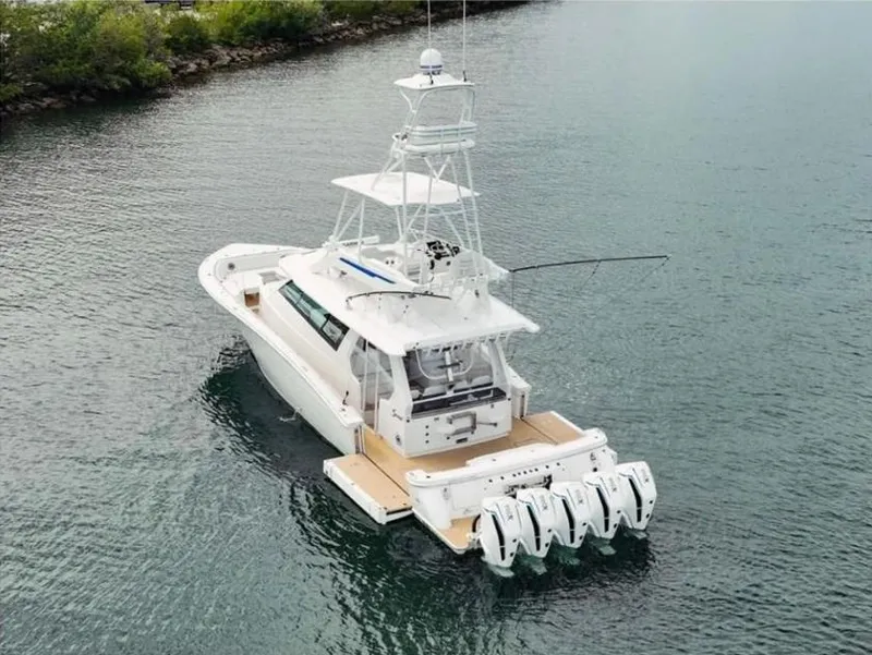 Slide: The Image of 2021 Scout 530 LXF boat with multiple engines on calm water. - 4