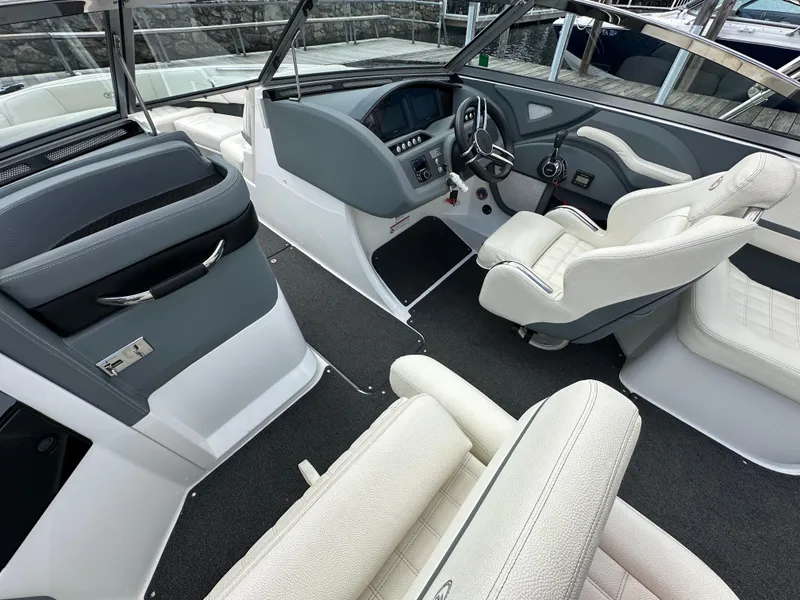 Slide: The Image of 2021 Cobalt R5 boat interior with white and gray seating, modern dashboard, and steering wheel. - 11