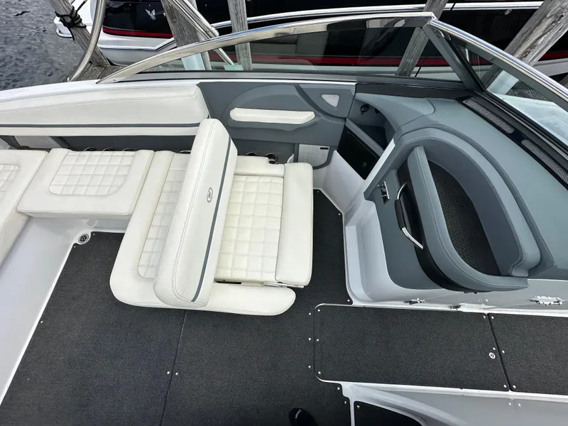 Slide: The Image of Interior of a 2021 Cobalt R5 boat with white cushioned seating and sleek design. - 12