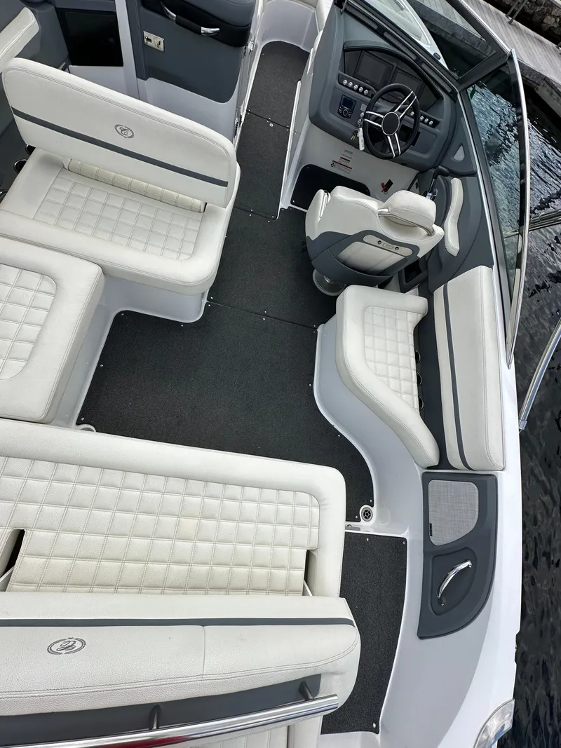 Slide: The Image of 2021 Cobalt R5 boat interior with white cushioned seating and sleek dashboard design. - 15