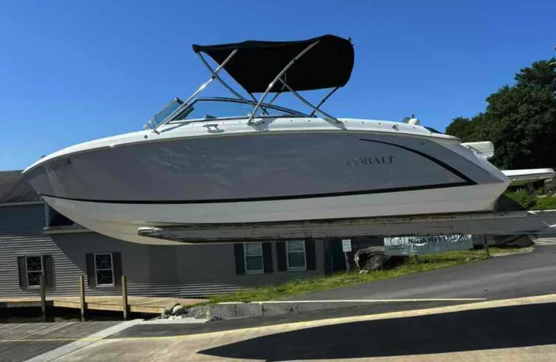 Slide: The Image of 2021 Cobalt R5 boat with black canopy, docked on a sunny day. - 22