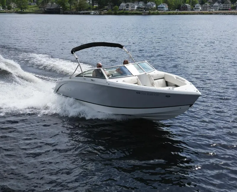 Slide: The Image of 2021 Cobalt R5 boat cruising on a lake with two passengers. - 29