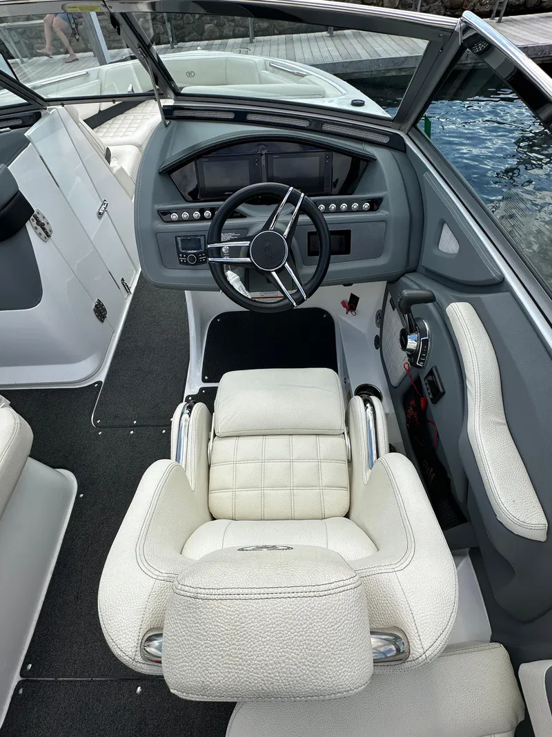Slide: The Image of 2021 Cobalt R5 boat interior with steering wheel and white leather seating. - 9