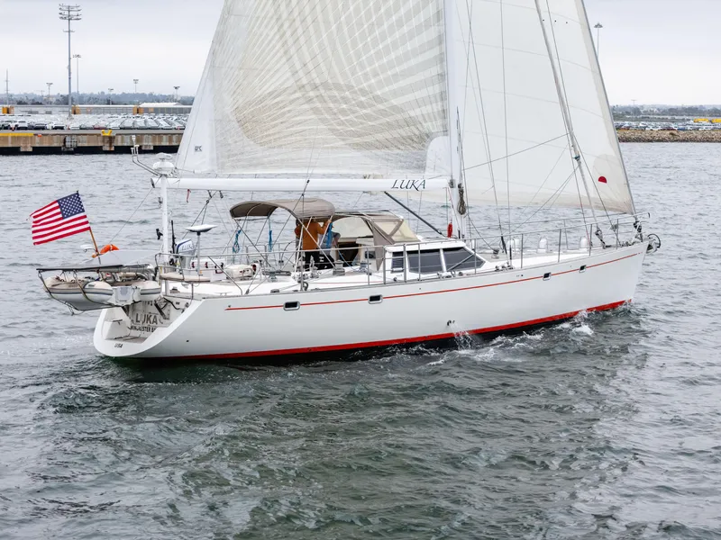 Slide: The Image of Sailing yacht Farr 60 Pilot House, 1997 model, cruising with American flag in harbor. - 10