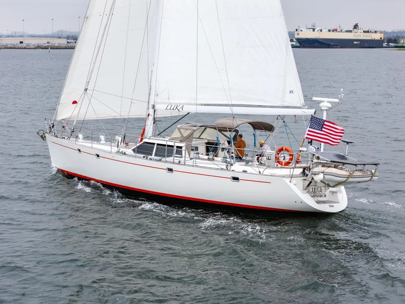Slide: The Image of Sailing yacht Farr 60 Pilot House 1997 on open water with American flag. - 2