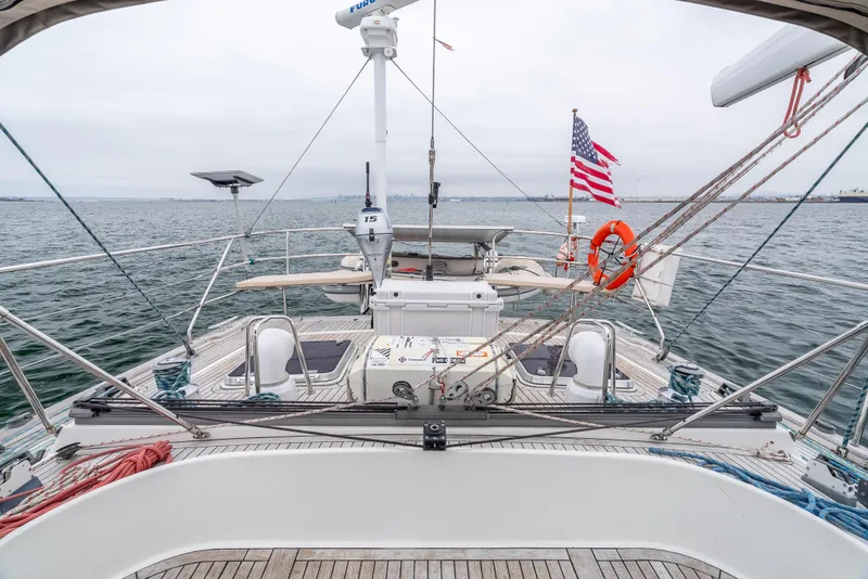 Slide: The Image of Sailing yacht Farr 60 Pilot House 1997 on open water with American flag. - 20