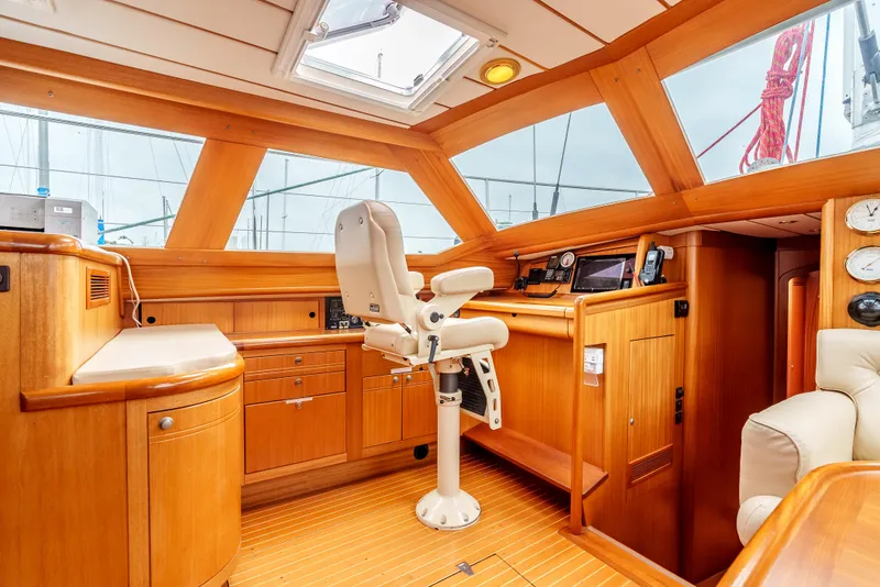 Slide: The Image of Luxurious 1997 Farr 60 Pilot House interior with wooden finish and navigation equipment. - 27