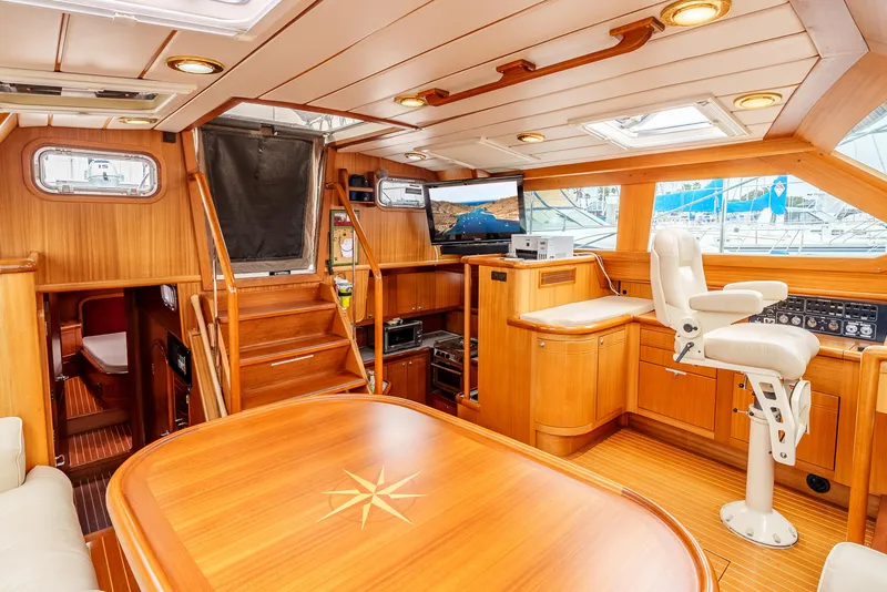 Slide: The Image of Luxurious 1997 Farr 60 Pilot House interior with wood finish and navigation station. - 29