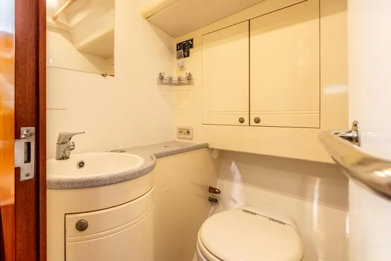Slide: The Image of Bathroom interior of 1997 Farr 60 Pilot House yacht, featuring sink and toilet. - 42