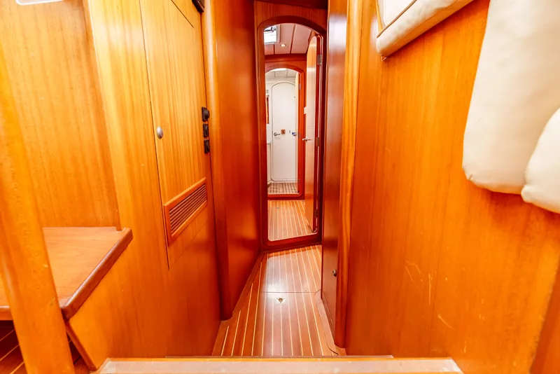 Slide: The Image of Interior hallway of 1997 Farr 60 Pilot House yacht with wooden paneling. - 43