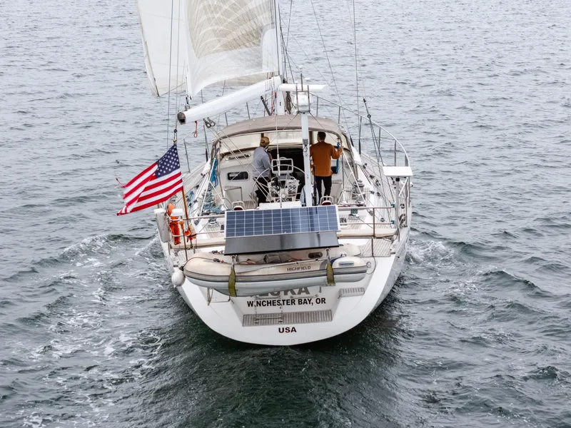 Slide: The Image of Sailing yacht Farr 60 Pilot House 1997 on open water, displaying American flag. - 8