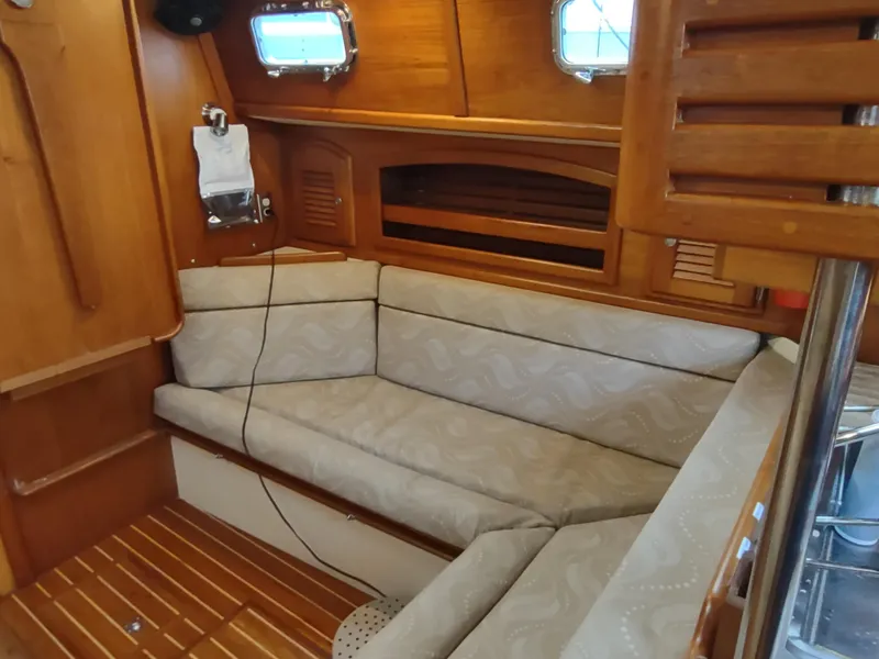 Slide: The Image of Interior of 1997 Pacific Seacraft 37 sailboat with cozy seating and wooden accents. - 33