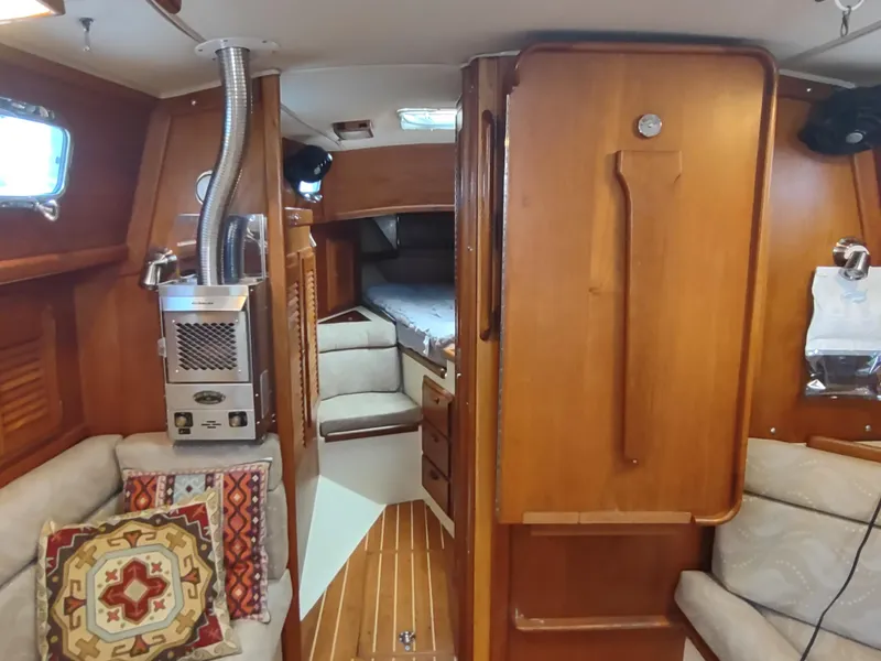 Slide: The Image of Interior of 1997 Pacific Seacraft 37 sailboat with wood finish and cozy seating area. - 35