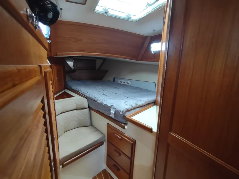 Slide: The Image of Interior of 1997 Pacific Seacraft 37 sailboat with cozy cabin and wooden furnishings. - 37