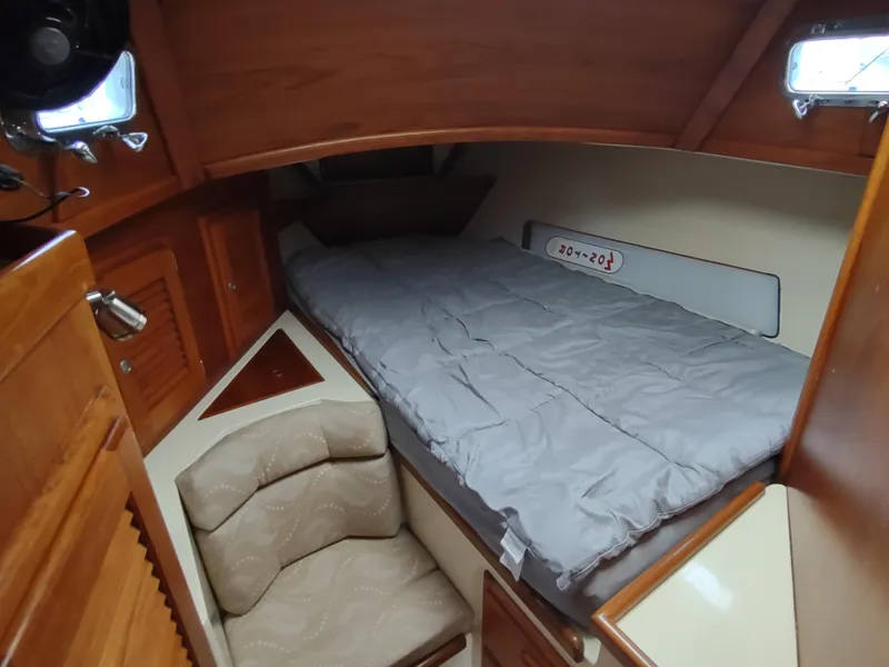 Slide: The Image of Cozy cabin interior of 1997 Pacific Seacraft 37 sailboat with bed and seating area. - 38