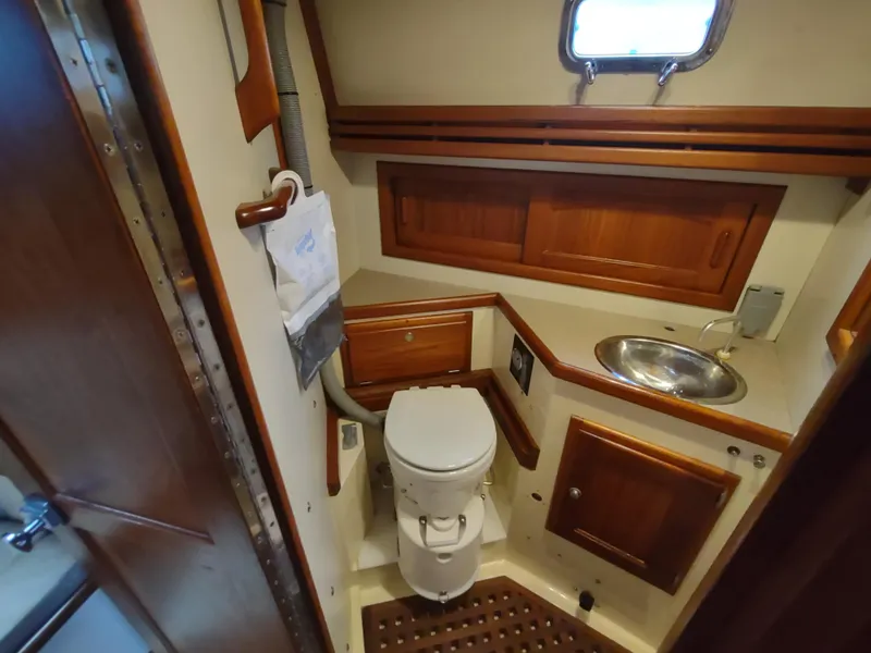 Slide: The Image of Bathroom interior of a 1997 Pacific Seacraft 37 sailboat with wooden cabinetry. - 39