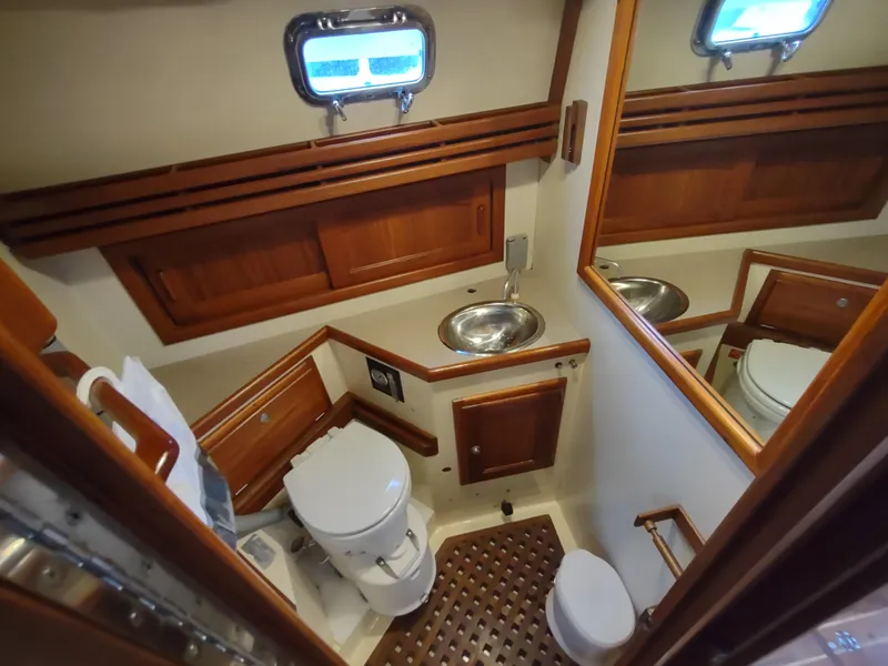Slide: The Image of Bathroom interior of 1997 Pacific Seacraft 37 yacht with wooden accents and stainless steel sink. - 40