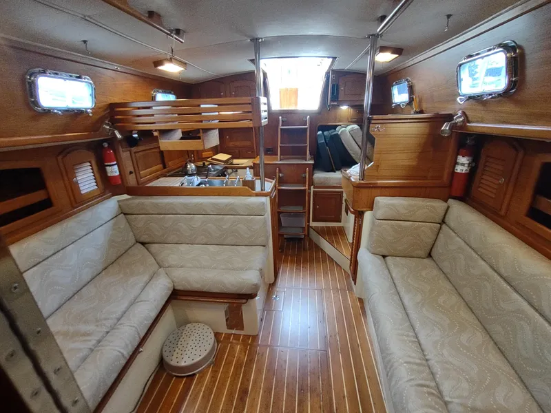 Slide: The Image of Interior of 1997 Pacific Seacraft 37 sailboat with wooden finish and cushioned seating. - 41