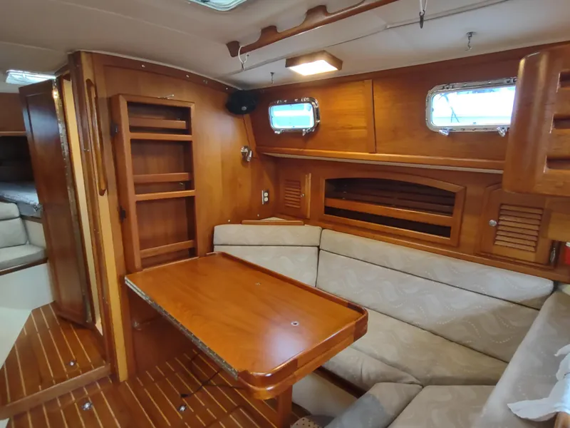 Slide: The Image of Interior of 1997 Pacific Seacraft 37 sailboat with wooden furnishings and cozy seating area. - 44