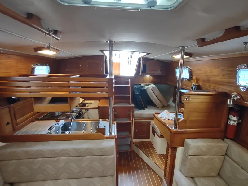 Slide: The Image of Interior of 1997 Pacific Seacraft 37 sailboat with wood finish and cozy seating area. - 45