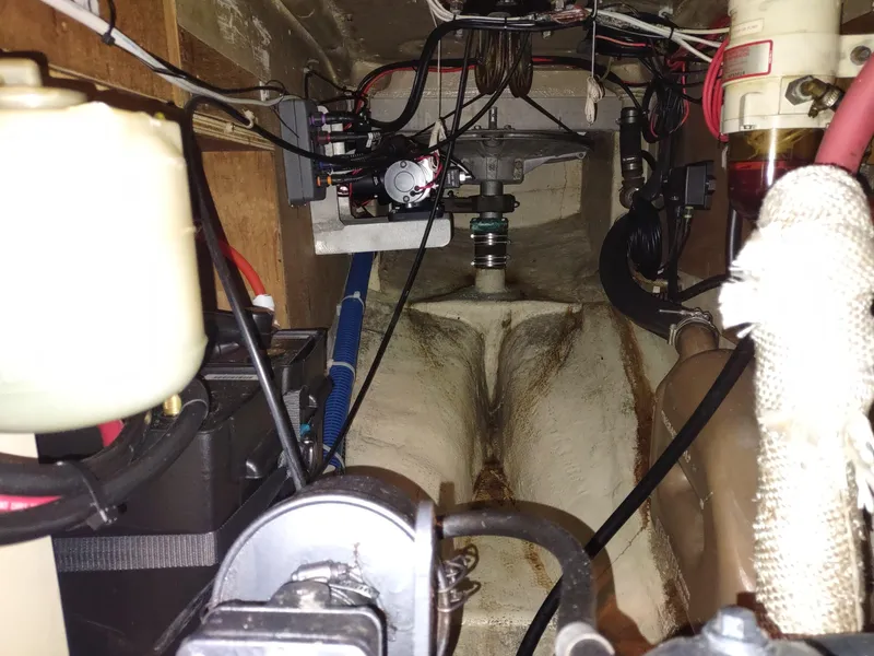 Slide: The Image of Engine compartment of a 1997 Pacific Seacraft 37 sailboat, showing mechanical components and wiring. - 47
