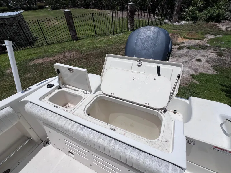 Slide: The Image of 2005 Hydra-Sports Vector 2400 CC boat with open storage compartments and engine view. - 15