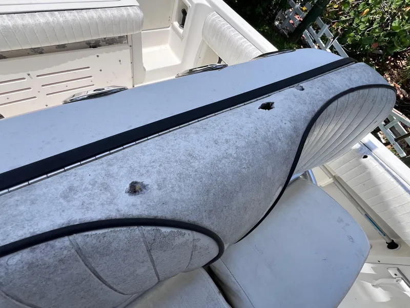 Slide: The Image of 2005 Hydra-Sports Vector 2400 CC boat seat with visible wear and damage. - 19