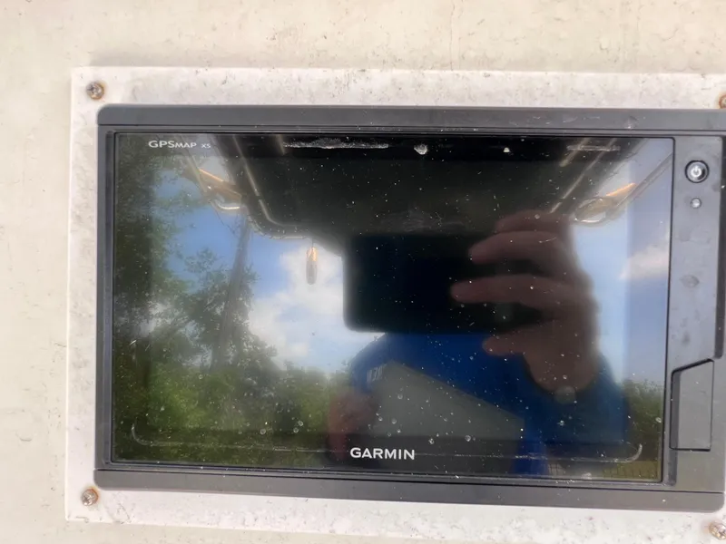 Slide: The Image of Garmin GPS display on 2005 Hydra-Sports Vector 2400 CC boat, reflecting sky and trees. - 22